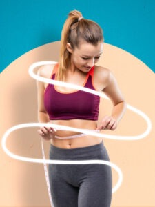 A woman measuring her stomach with a tape.