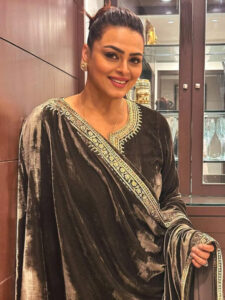 Shilpa Shirodkar posing in a brown velvet suit with a dupatta, looking fit and confident.