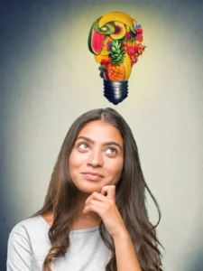 A young woman wearing spectacles with healthy diet idea flashing on her head in the shape of a lightbulb.