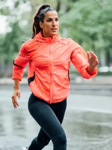 A fit young woman out for a run in the rain.