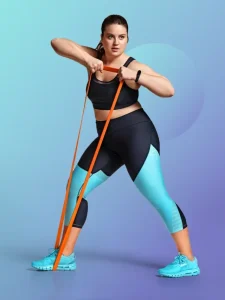 A plump woman working out with resistance band at home.